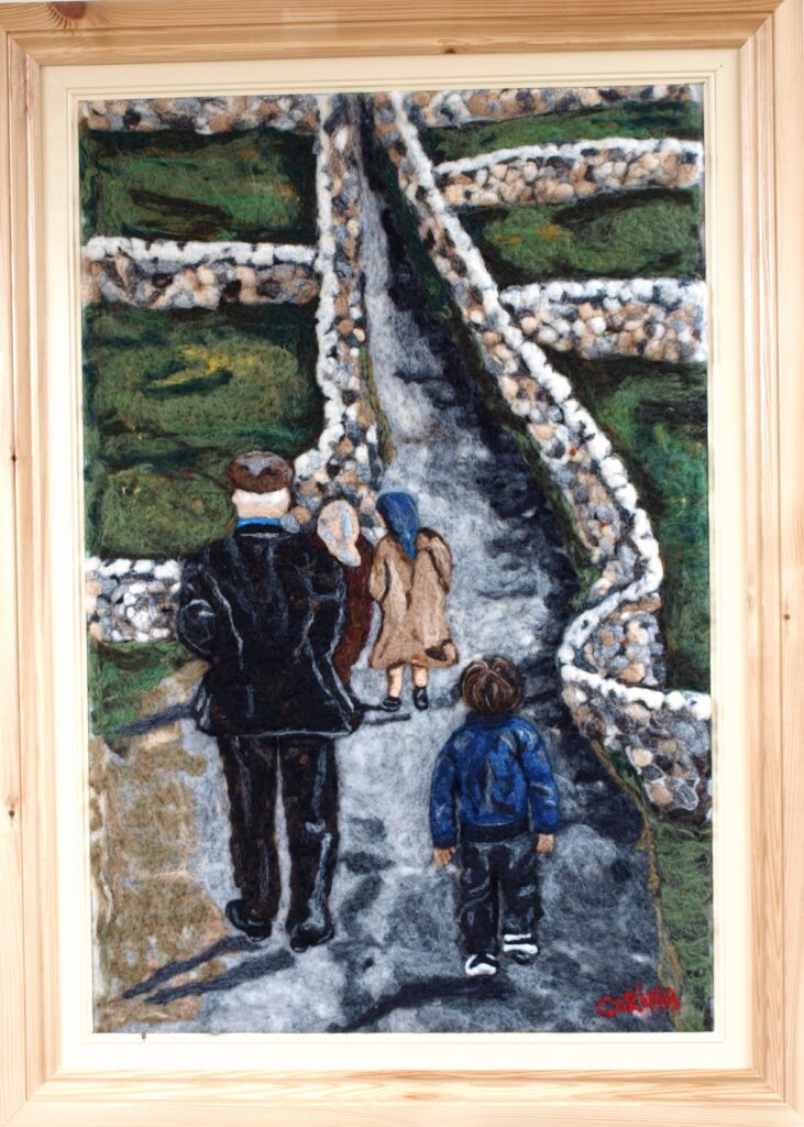 needle-felted painting of people walking up path on the aran islands