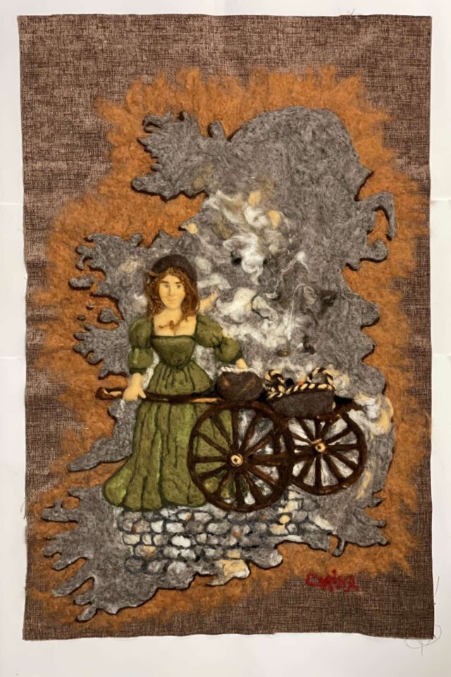 Molly Malone by Corina Hogan, a wool picture of a woman in a green dress beside a wheelbarrow on a cobbled street.