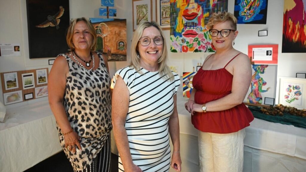 Corina Hogan with fellow artists and artwork at the Sonder exhibition in the GRETB FET Centre, Tuam.